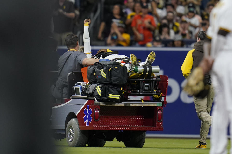 San Diego Padres left fielder Jurickson Profar reacts on a cart after colliding with shortstop C.J. Abrams during the fifth inning of a baseball game against the San Francisco Giants, Thursday, July 7, 2022, in San Diego. Profar and Abrams collided as Abrams made a catch for an out against Giants' Tommy La Stella. (AP Photo/Gregory Bull)