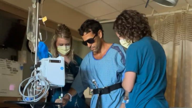 <span class="article__caption">The author taking his first walk in the hospital after his stroke and surgery.</span> (Photo: Rebecca Chase)