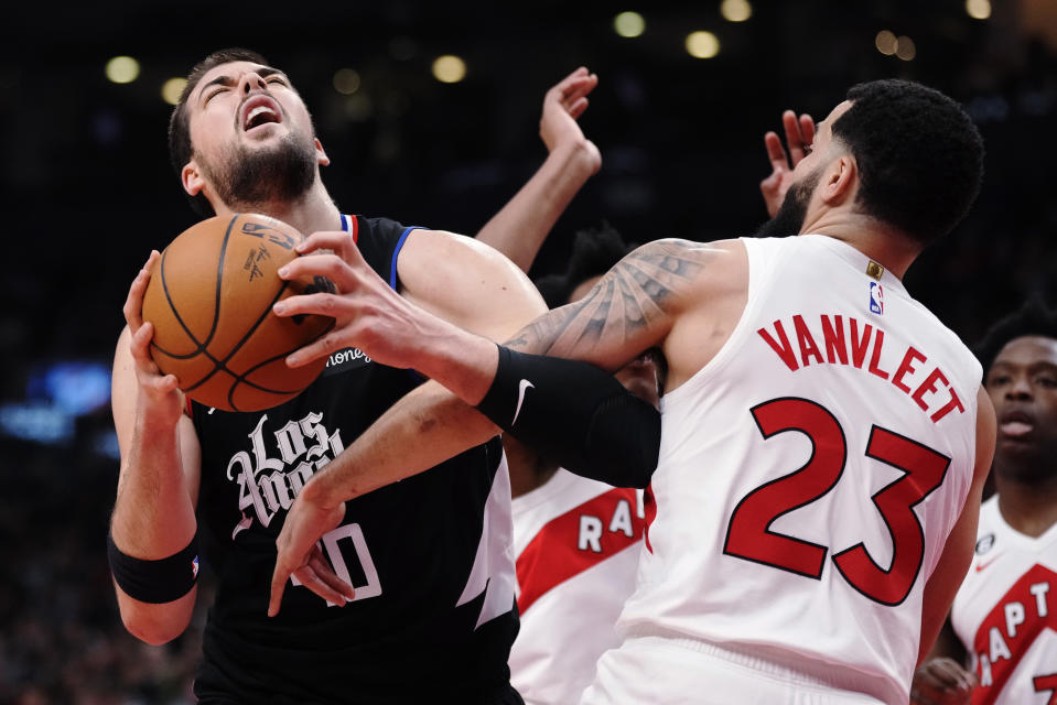 Los Angeles Clippers center Ivica Zubac (40) is defended by Toronto Raptors guard Fred VanVleet (23) during the first half of an NBA basketball game Tuesday, Dec. 27, 2022, in Toronto. (Frank Gunn/The Canadian Press via AP)