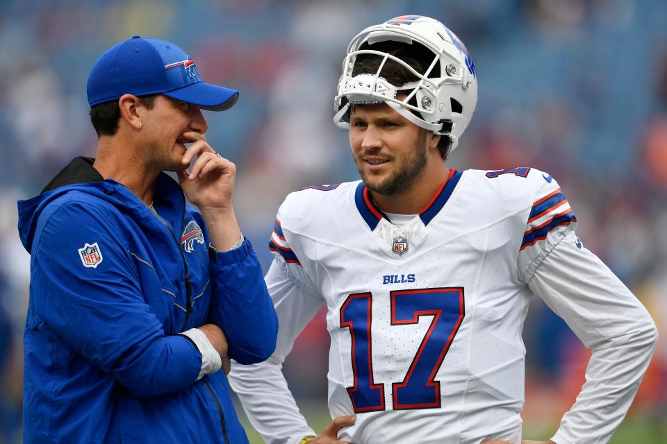 Buffalo Bills offensive coordinator Ken Dorsey, left, talks with quarterback Josh Allen (17) before an NFL preseason football game against the Indianapolis Colts in Orchard Park, N.Y., Saturday, Aug. 12, 2023. (AP Photo/Adrian Kraus)