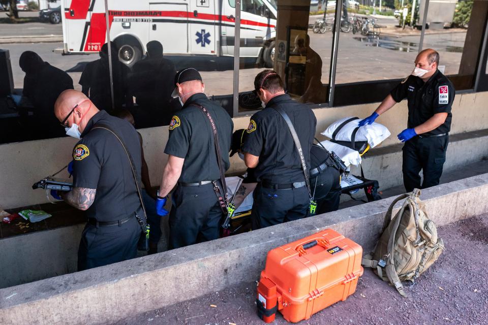 Salem Fire Department paramedics and employees of Falck Northwest ambulance service respond to a heat exposure call during a heat wave in June 2021.