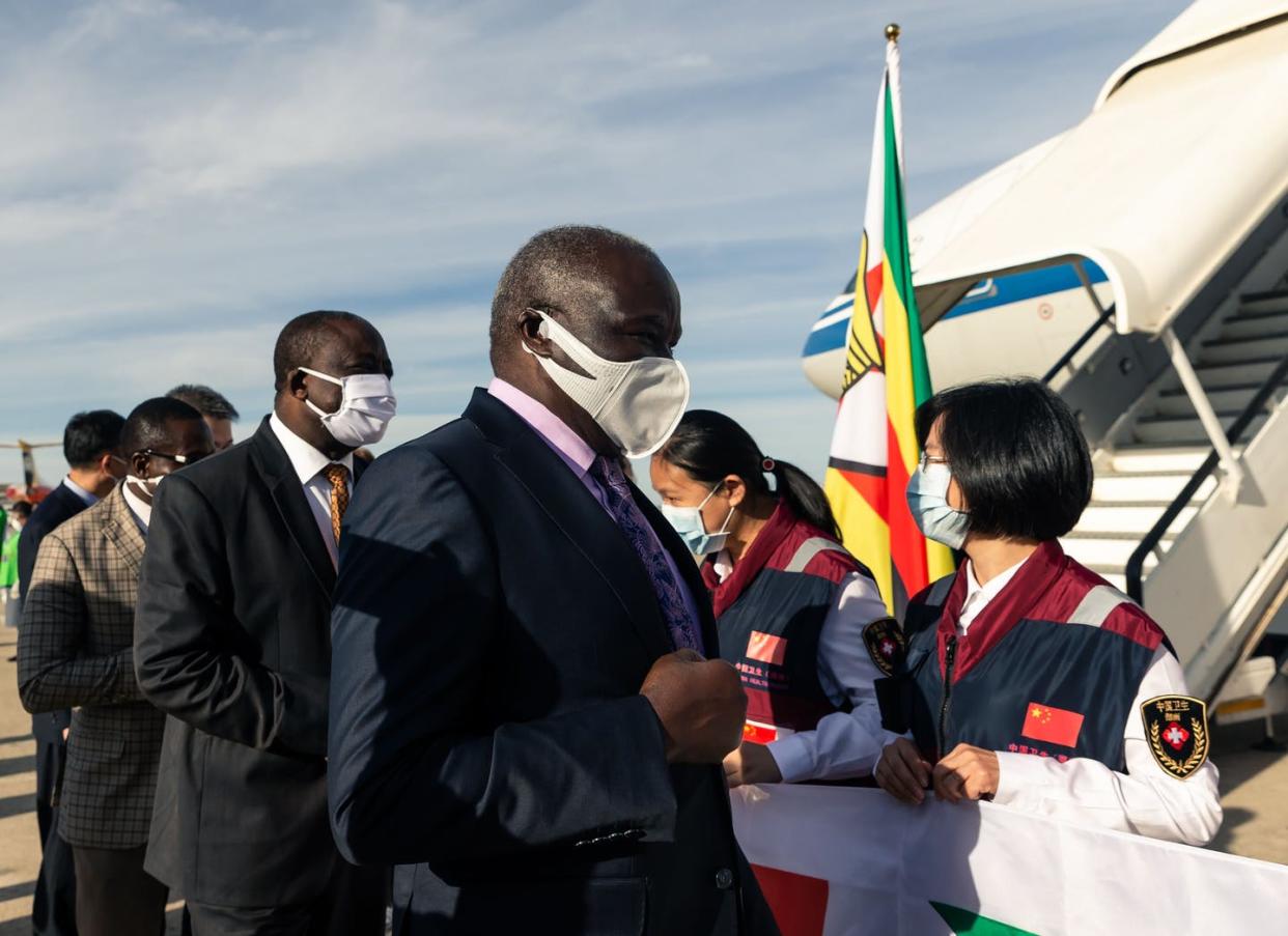 <span class="caption">Zimbabwe leaders welcome Chinese COVID-19 experts at the Robert Mugabe International Airport in Harare on May 11, 2020.</span> <span class="attribution"><a class="link " href="https://www.gettyimages.com/detail/news-photo/zimbabwe-minister-of-local-government-and-social-welfare-news-photo/1212652388?adppopup=true&uiloc=thumbnail_more_search_results_adp" rel="nofollow noopener" target="_blank" data-ylk="slk:Jekesai Njikizana/AFP via Getty Images;elm:context_link;itc:0;sec:content-canvas">Jekesai Njikizana/AFP via Getty Images</a></span>