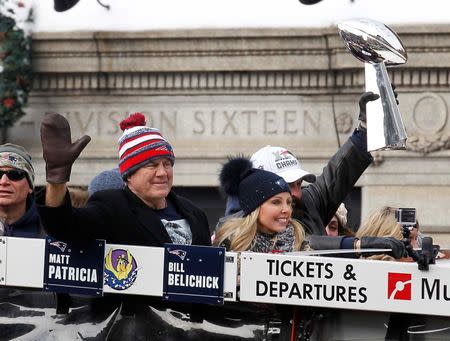 Feb 4, 2015; Boston, MA, USA; New England Patriots coach Bill Belichick (left) waves to the crowd as defensive coordinator Matt Patricia holds the Vince Lombardi Trophy during the Super Bowl XLIX victory parade. Stew Milne-USA TODAY Sports