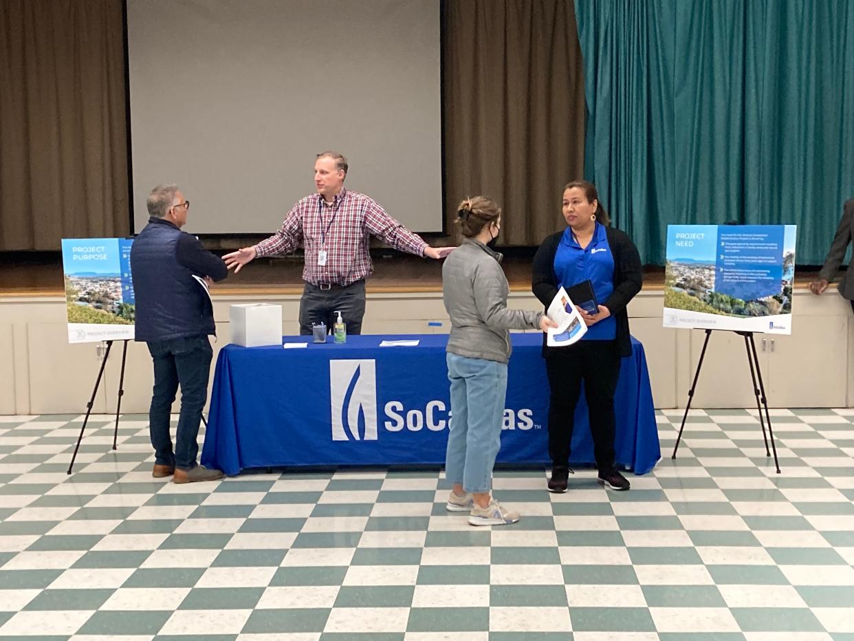 Brian Walker and Maria Ventura, both with SoCalGas, discuss plans to modernize the Ventura gas compressor station at a community event Thursday.