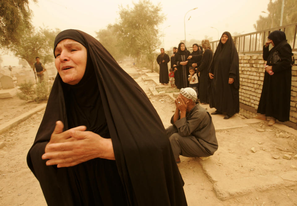 The grandmother (L) and other relatives mourn during a funeral for a neighbourhood patrol member in a dust storm in northern Baghdad September 16, 2008. A member of a neighbourhood patrol was killed and his companion was left wounded after a bomb planted on their car exploded while they were driving on Monday in Adhamiya district, police said REUTERS/Omar Obeidi (IRAQ)