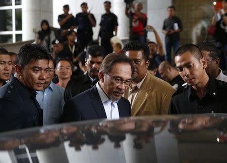 Malaysia's opposition leader Anwar Ibrahim leaves the court during his final appeal against a conviction for sodomy at the Palace of Justice in Putrajaya October 30, 2014. REUTERS/Olivia Harris