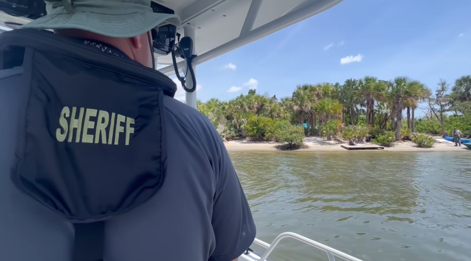 Law enforcement officers boat out Friday to post trespassing notices on islands near the Dunlawton Bridge in Port Orange.