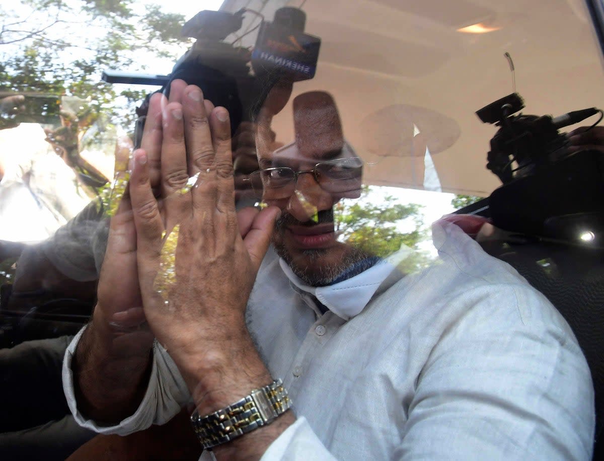 Bishop Franco Mulakkal greets the media as he leaves a court in Kottayam, India on 14 January 2022  (AP)