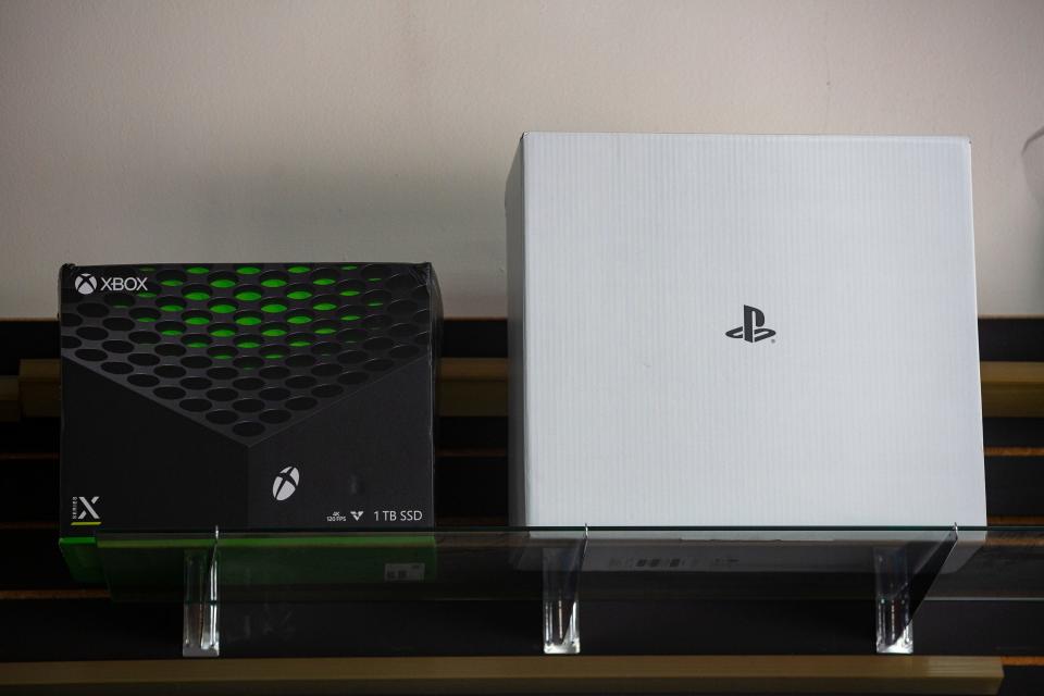 A display box for a XBox Series X and Playstation 5 sit on a shelf at Play It! Games, Music and Movies located at 4324 N. High St. in Columbus. The store has had a difficult time acquiring Playstation 5s due to the microchip shortage affecting production of the new consoles.
