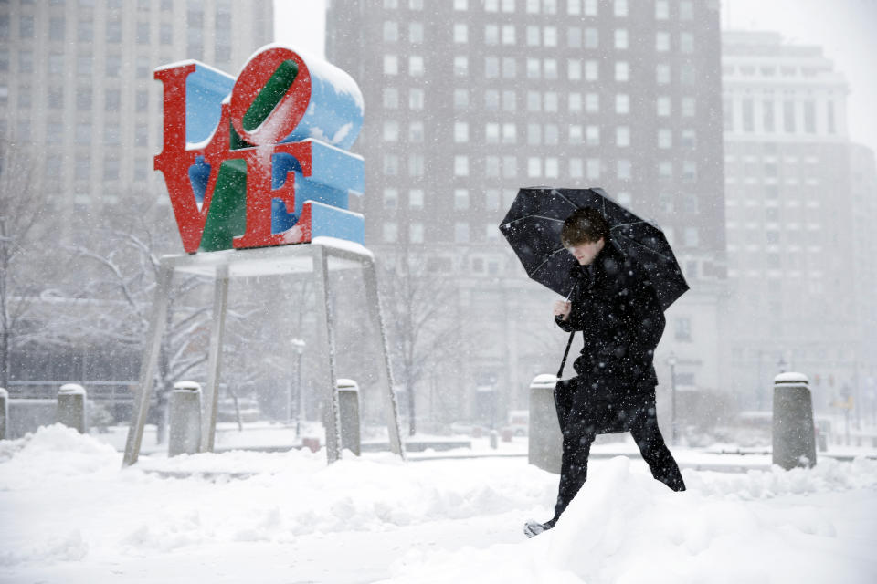A man walks through the snow, Thursday, March 5, 2015, during a winter storm at JFK Plaza, commonly known as Love Park, in Philadelphia. For much of the Eastern United States, the winter of 2023 has been a bust. Snow totals are far below average from Boston to Philadelphia in 2023 and warmer temperatures have often resulted in more spring-like days than blizzard-like conditions. (AP Photo/Matt Rourke, File)