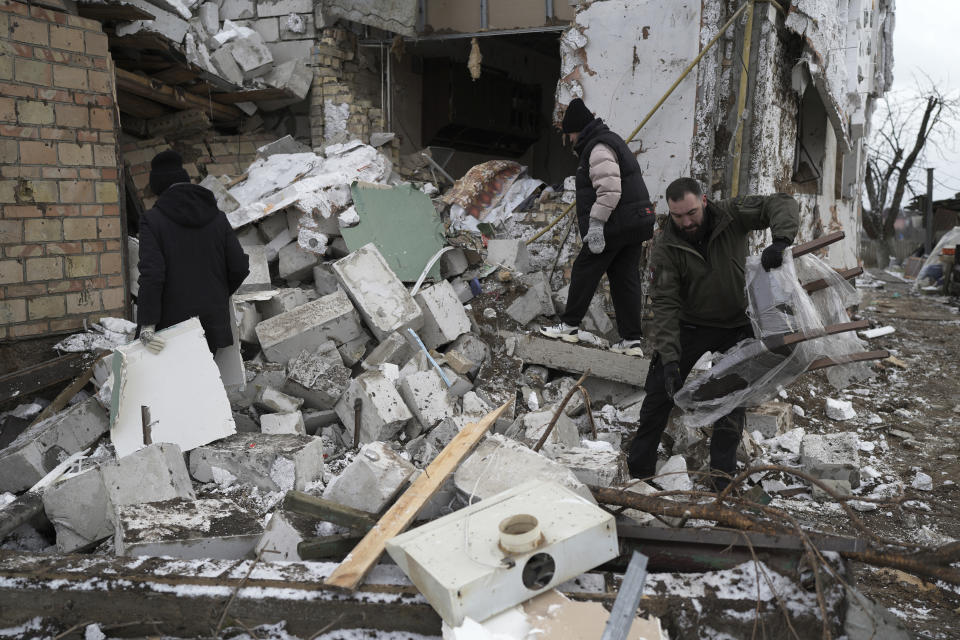 People check a destroyed house after a Russian rocket attack in Hlevakha, Kyiv region, Ukraine, Thursday, Jan. 26, 2023. (AP Photo/Roman Hrytsyna)