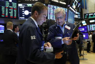 Traders Dudley Devine, left, and Christopher Fuchs work on the floor of the New York Stock Exchange, Friday, Aug. 16, 2019. Stocks are opening broadly higher at the end of a turbulent week. (AP Photo/Richard Drew)