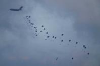 An aircraft airdrops humanitarian aid over Gaza the northern Gaza Strip, as seen from southern Israel, Friday, March 8, 2024. (AP Photo/Leo Correa)