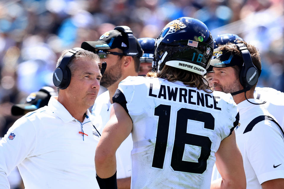 JACKSONVILLE, FLORIDA - SEPTEMBER 26: Head coach Urban Meyer (L) of the Jacksonville Jaguars speaks with Trevor Lawrence #16 during the game against the Arizona Cardinals at TIAA Bank Field on September 26, 2021 in Jacksonville, Florida. (Photo by Sam Greenwood/Getty Images)