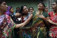 Relatives of residents trapped under the rubble react at the site of a collapsed residential building in Mumbai September 27, 2013. (REUTERS/Danish Siddiqui)