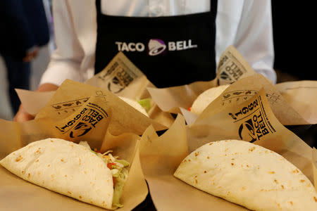 A server holds food during the opening ceremony of a Taco Bell restaurant in Bangkok, Thailand January 22, 2019. REUTERS/Soe Zeya Tun