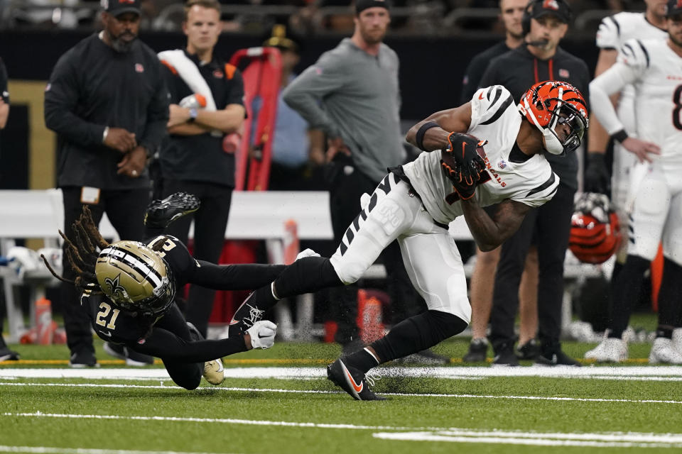 Cincinnati Bengals wide receiver Ja'Marr Chase (1) breaks the tackle of New Orleans Saints cornerback Bradley Roby (21) and runs for a touchdown during the second half of an NFL football game in New Orleans, Sunday, Oct. 16, 2022. (AP Photo/Gerald Herbert)