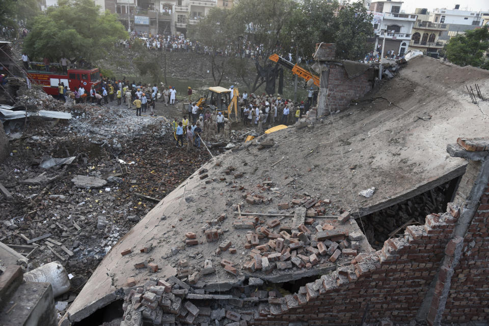 Rescuers work at the site of an explosion at a fireworks factory in Batala, in the northern Indian state of Punjab, Wednesday, Sept. 4, 2019. More than a dozen people were killed in the explosion that caused the building to catch fire and collapse, officials said. (AP Photo/Prabhjot Gill)
