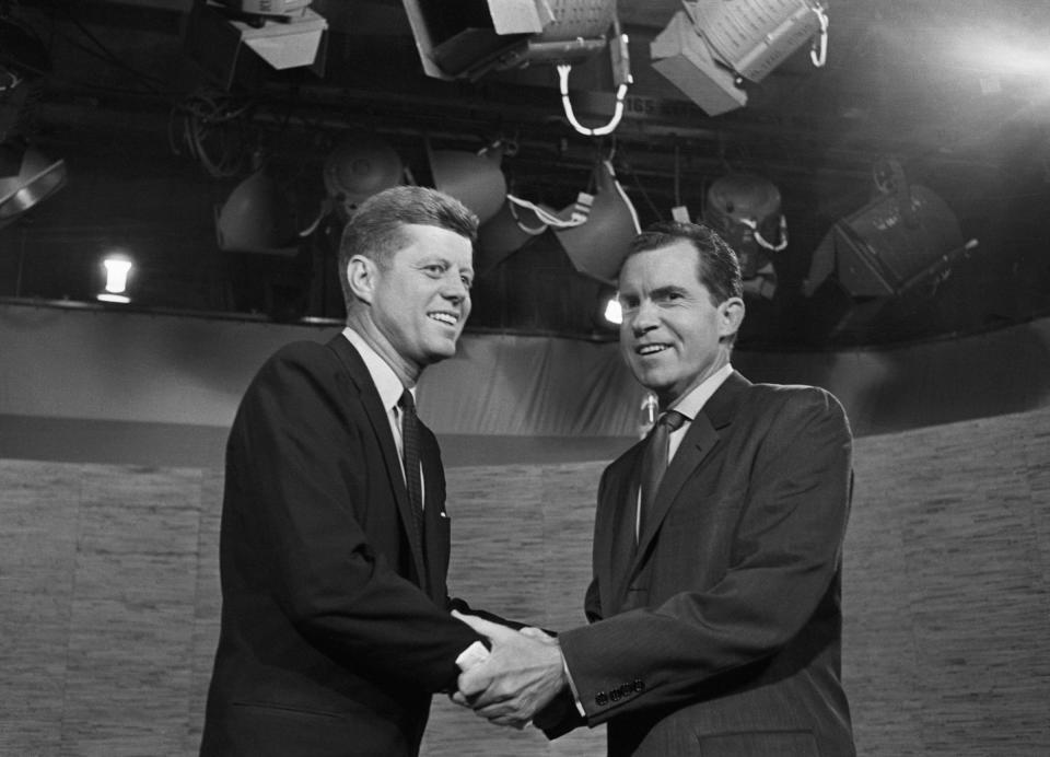 Presidential candidates John F. Kennedy and Richard Nixon shake hands after their televised debate of October 7, 1960. The two opponents continued their debate after the cameras had stopped.<span class="copyright">Bettmann Archive</span>