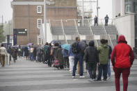 People queue at an NHS Vaccination Clinic at Tottenham Hotspur's stadium in north London, Sunday, June 20, 2021. The NHS is braced for high demand as anyone in England over the age of 18 can now book a Covid-19 vaccination jab. (Yui Mok/PA via AP)