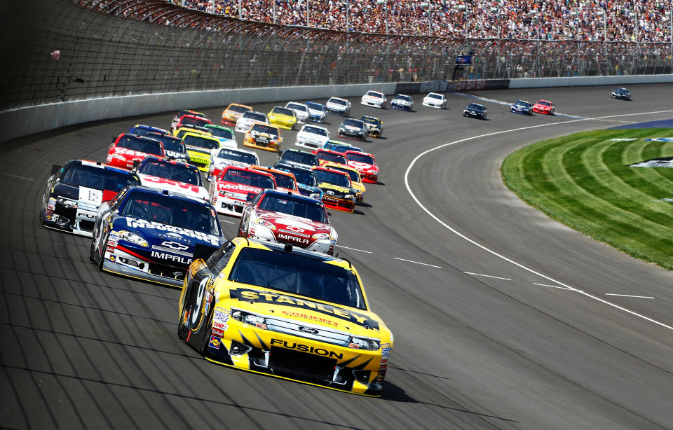 BROOKLYN, MI - JUNE 17: Marcos Ambrose, driver of the #9 Stanley Ford, leads the field in the NASCAR Sprint Cup Series Quicken Loans 400 at Michigan International Speedway on June 17, 2012 in Brooklyn, Michigan. (Photo by Jeff Zelevansky/Getty Images)