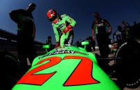 FORT WORTH, TX - JUNE 08: James Hinchcliffe of Canada, driver of the #27 Team GoDaddy.com Chevrolet Dallara, climbs into his car for qualifying for the IZOD IndyCar Series Firestone 550 at Texas Motor Speedway on June 8, 2012 in Fort Worth, Texas. (Photo by Jonathan Ferrey/Getty Images)