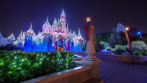 Disney's Sleeping Beauty Castle lit up at night.