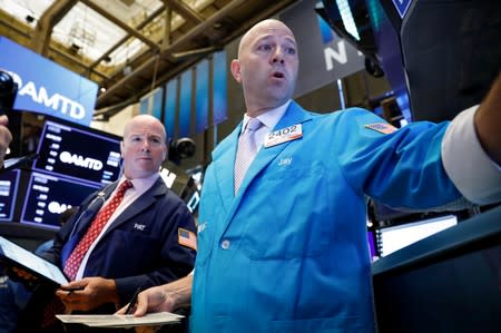 Traders work on the floor at the NYSE in New York