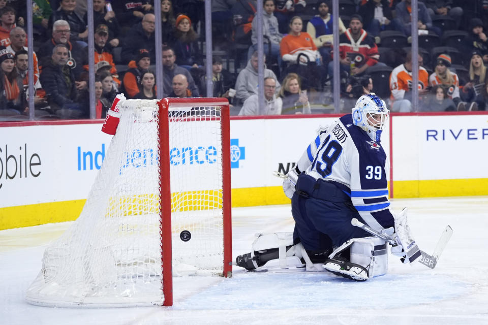 Winnipeg Jets' Laurent Brossoit, looks back at a goal scored by Philadelphia Flyers' Ryan Poehling during the second period of an NHL hockey game, Thursday, Feb. 8, 2024, in Philadelphia. (AP Photo/Matt Slocum)