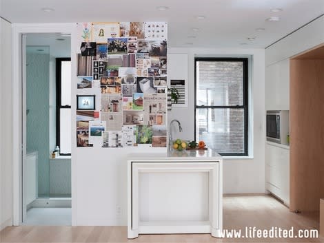 A view of the kitchen and bathroom areas. The table tucked under the counter pulls out to seat 10 guests. (Photo: Matthew Williams for Life Edited)