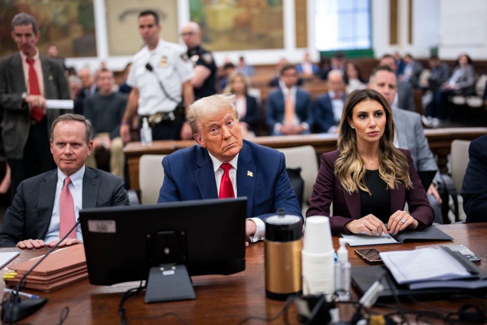 Donald Trump appears with his attorneys Christopher Kise, left, and Alina Habba, right, in New York Superior Court on 17 October. (Getty Images)