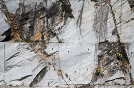 Workers known as "Tecchiaioli" examine marble at the Cervaiole quarry on Monte Altissimo in the Apuan Alps, Tuscany, Italy, July 18, 2017. REUTERS/Alessandro Bianchi