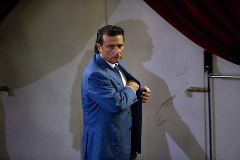 Captain Francesco Schettino leaves the court room of the converted Teatro Moderno theater on the second day of his trial, in Grosseto, Italy, Tuesday, Sept. 24, 2013. The captain of the wrecked Costa Concordia is charged with manslaughter, causing the shipwreck and abandoning ship before the luxury cruise liner's 4,200 passengers and crew could be evacuated on Jan. 13, 2012 when the ship collided with a reef off the Tuscan island of Giglio, killing 32 people. Schettino blames his helmsman for botching a last-minute corrective maneuver that he contends could have prevented the massive cruise ship's collision with the reef. (AP Photo/Andrew Medichini)