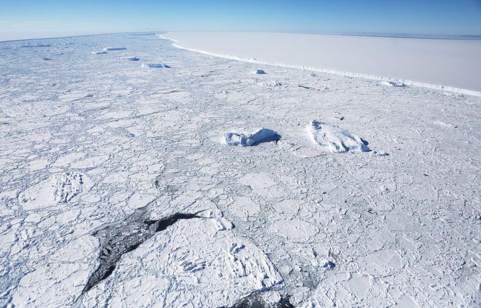 UNSPECIFIED, ANTARCTICA - OCTOBER 31:  The western edge of the famed iceberg A-68 (TOP R), calved from the Larsen C ice shelf, is seen from NASA's Operation IceBridge research aircraft, near the coast of the Antarctic Peninsula region, on October 31, 2017, above Antarctica. The massive iceberg was measured at approximately the size of Delaware when it first calved in July. NASA's Operation IceBridge has been studying how polar ice has evolved over the past nine years and is currently flying a set of nine-hour research flights over West Antarctica to monitor ice loss aboard a retrofitted 1966 Lockheed P-3 aircraft. According to NASA, the current mission targets 'sea ice in the Bellingshausen and Weddell seas and glaciers in the Antarctic Peninsula and along the English and Bryan Coasts.' Researchers have used the IceBridge data to observe that the West Antarctic Ice Sheet may be in a state of irreversible decline directly contributing to rising sea levels. The National Climate Assessment, a study produced every 4 years by scientists from 13 federal agencies of the U.S. government, released a stark report November 2 stating that global temperature rise over the past 115 years has been primarily caused by 'human activities, especially emissions of greenhouse gases'.  (Photo by Mario Tama/Getty Images)