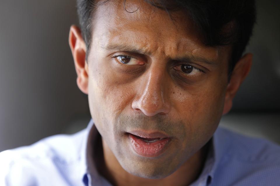 FILE - In this July 20, 2010 file photo, Louisiana Gov. Bobby Jindal talks about the oil spill as he flies over the Deepwater Horizon oil spill site in the Gulf of Mexico, off the Louisiana coast. Jindal left the Louisiana governor’s office nearly four years ago and evaporated from the state political scene after a failed presidential bid. Still, he’s a permanent fixture in the current governor’s race. Democratic incumbent John Bel Edwards keeps his Republican predecessor front and center in his quest for a second term. Edwards frames his GOP opponents as another version of Jindal, whose financial policies are blamed for the state’s past decade of budget troubles. (AP Photo/Gerald Herbert, File)