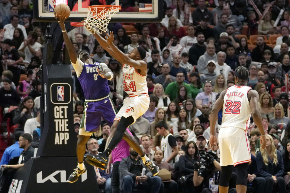 Milwaukee Bucks forward Bobby Portis (9) goes to the basket as Miami Heat forward Haywood Highsmith (24) defends during the second half of an NBA basketball game, Saturday, Jan. 14, 2023, in Miami. Miami won 111-95. (AP Photo/Lynne Sladky)