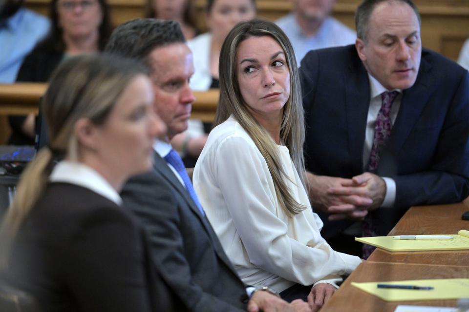 Karen Read, center, listens as the prosecutor questions Dr. Marie Russell, during Read's trial in Norfolk Superior Court, Friday, June 21, 2024, in Dedham, Mass. Read, 44, is accused of running into her Boston police officer boyfriend with her SUV in the middle of a nor'easter and leaving him for dead after a night of heavy drinking. (AP Photo/Josh Reynolds, Pool)