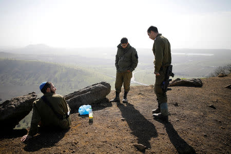 FILE PHOTO: Israeli soldiers stand in an open area near Mount Bental, an observation post in the Israeli-occupied Golan Heights that overlooks the Syrian side of the Quneitra crossing, Israel, January 21, 2019. REUTERS/Amir Cohen/File Photo