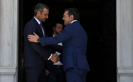 Newly-appointed Greek Prime Minister Mitsotakis meets with outgoing Prime Minister Tsipras in Athens