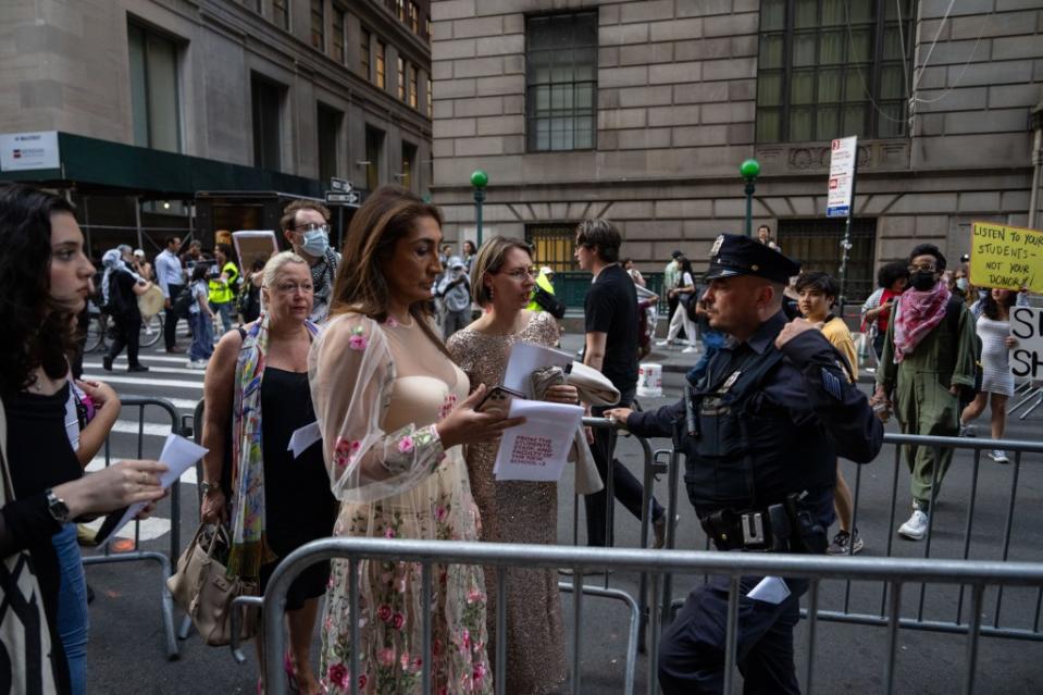 Guests arrive at the gala as protesters set up a picket line outside Cipriani Wall Street around 6:30 p.m. on Tuesday. Adam Gray for the New York Post
