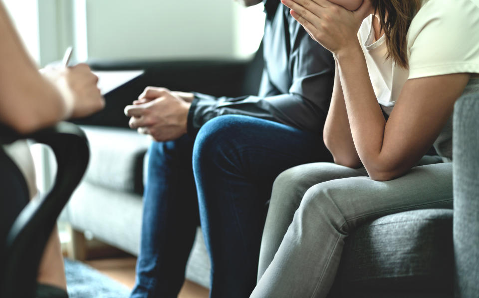 Hopeless and upset couple in therapy. Counseling or meeting with marriage counselor or adoption psychologist. Argument and dispute about divorce, alimony, prenup, cheating, betrayal or custody battle. (Getty Images)