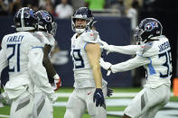 Tennessee Titans linebacker Nick Dzubnar (49) and defensive back Chris Jackson (35) celebrate a play against the Houston Texans during the first half of an NFL football game, Sunday, Jan. 9, 2022, in Houston. (AP Photo/Justin Rex )