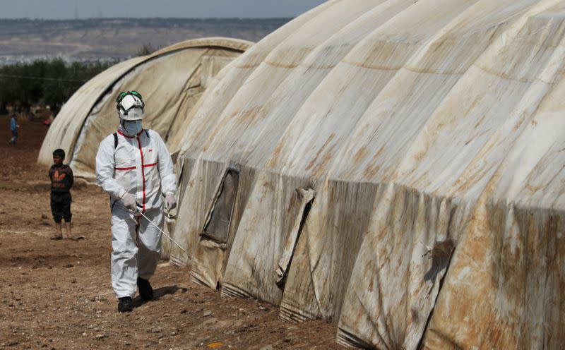 FILE PHOTO: A member of the Syrian Civil defence sanitizes a tent at the Bab Al-Nour internally displaced persons camp, to prevent the spread of coronavirus disease (COVID-19) in Azaz