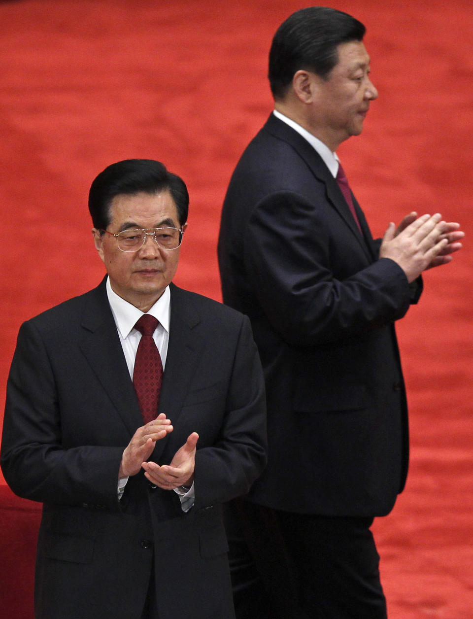 FILE - In this May 4, 2012 file photo, Chinese President Hu Jintao, front, and Vice President Xi Jinping, back, arrive at a conference to celebrate the 90th anniversary of the founding of Chinese Communist Youth League at the Great Hall of the People in Beijing, China. As Hu steps down as head of China’s Communist Party after 10 years in power, he’s hearing something unusual for a Chinese leader: sharp criticism. (AP Photo/Alexander F. Yuan, File)