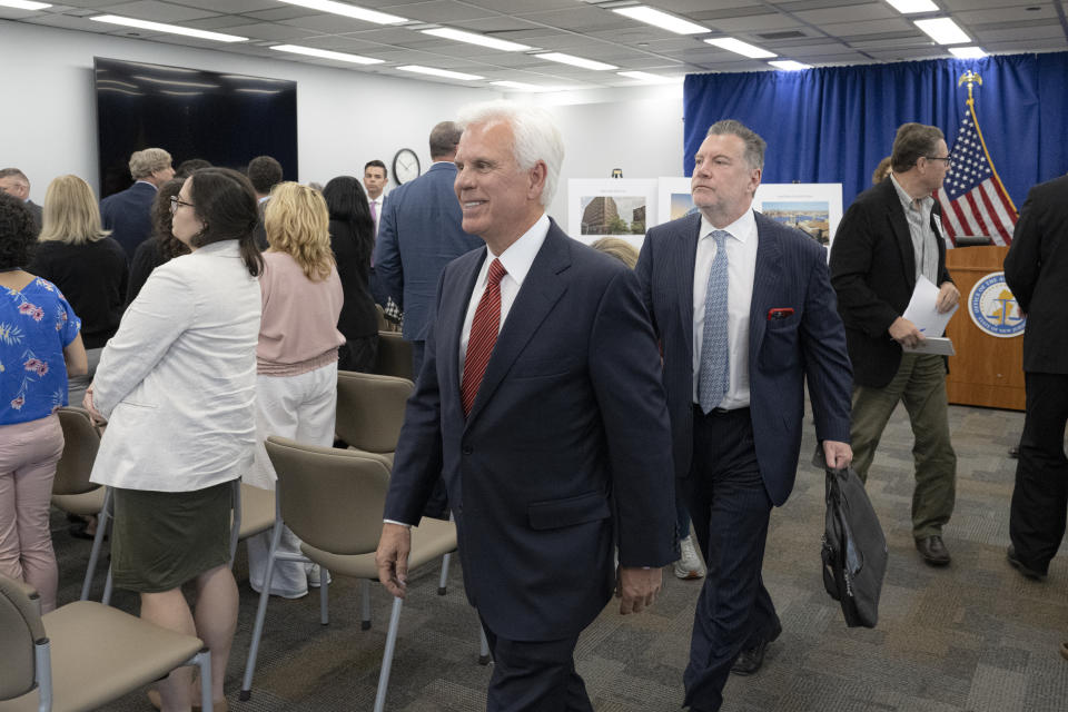 George Norcross, exits the room minutes after New Jersey Attorney General, Matthew Platkin's racketeering announcement on Monday, June 17, 2024 in Trenton, N.J. Norcross III was charged Monday with operating a racketeering enterprise, threatening people whose properties he sought to take over, and orchestrating tax incentive legislation to benefit organizations he controlled. (Jose F. Moreno/The Philadelphia Inquirer via AP)