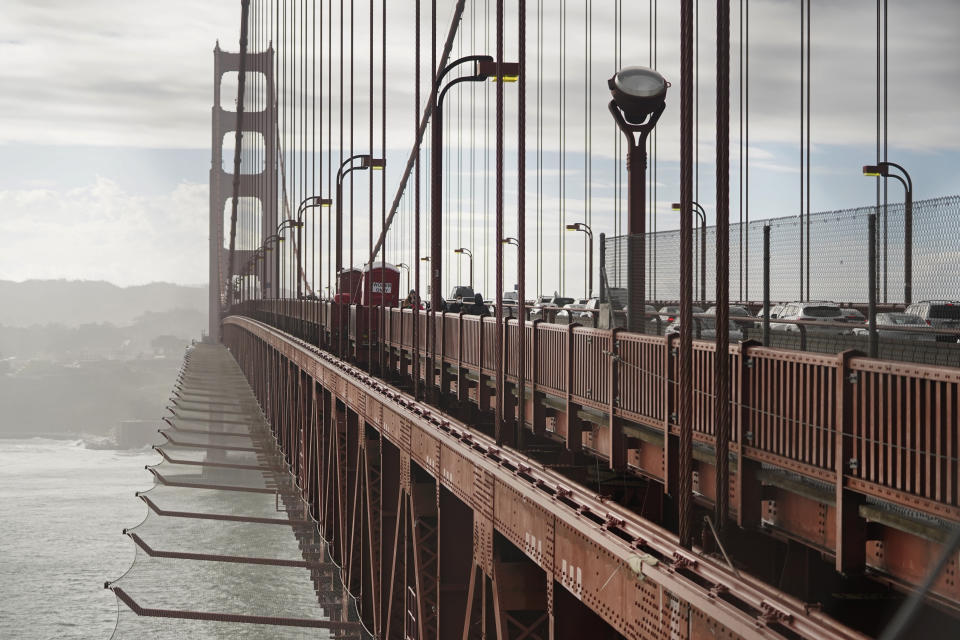 A suicide deterrent net is seen below the roadway on the Golden Gate Bridge in San Francisco, Wednesday, Dec. 6, 2023. The barrier at the bridge is near completion more than a decade after officials approved it. (AP Photo/Eric Risberg)