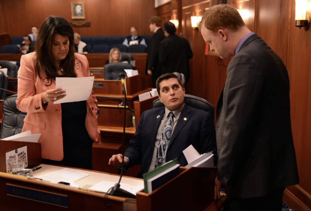 Rep. Jamie Allard, R-Eagle River (left) and Rep. David Eastman, R-Wasilla (right) talk with Rep. Justin Ruffridge, R-Soldotna, about an amendment to House Bill 183 on Thursday, May 9, 2024. (Photo by James Brooks/Alaska Beacon)