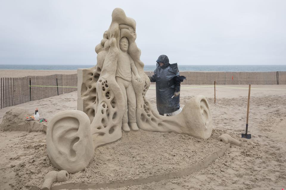 Rusty Croft of California works on "Audio Immersion" at the Hampton Beach Master Sand Sculpting Classic.