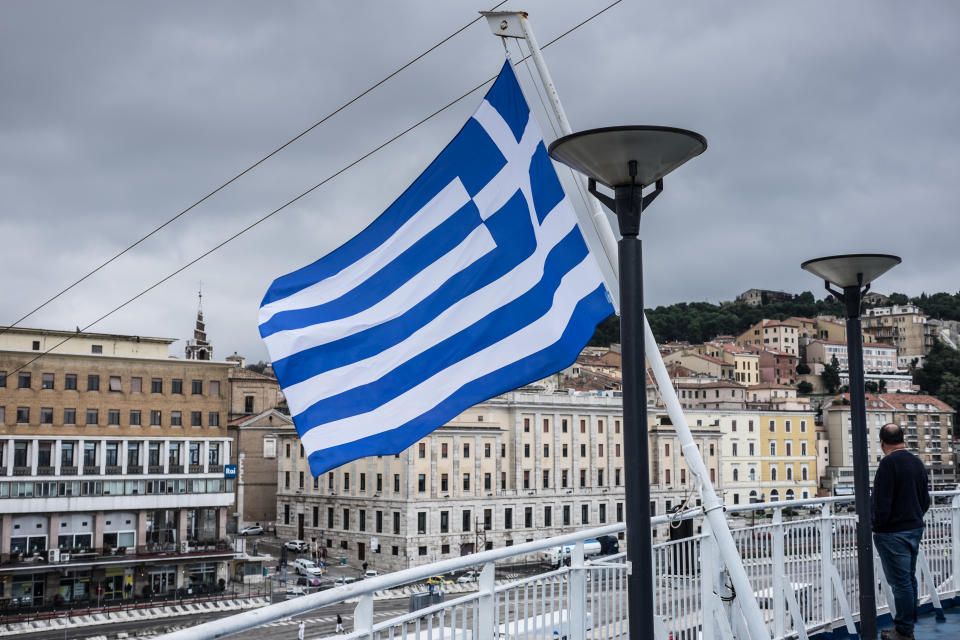 A man standing at a Greek Flag on a ship in the harbor of Ancona on November 20, 2019(Photo by Wassilios Aswestopoulos/NurPhoto via Getty Images)