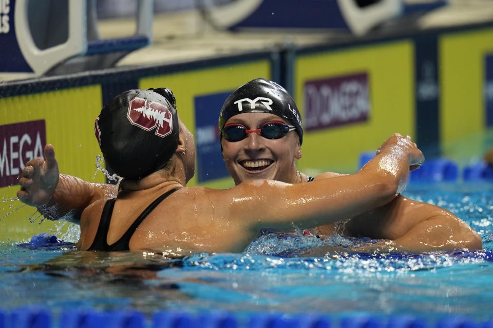 Katie Ledecky gets a hug from Katie McLaughlin after winning in the women's 200 freestyle during wave 2 of the U.S. Olympic Swim Trials on Wednesday, June 16, 2021, in Omaha, Neb.(AP Photo/Jeff Roberson)